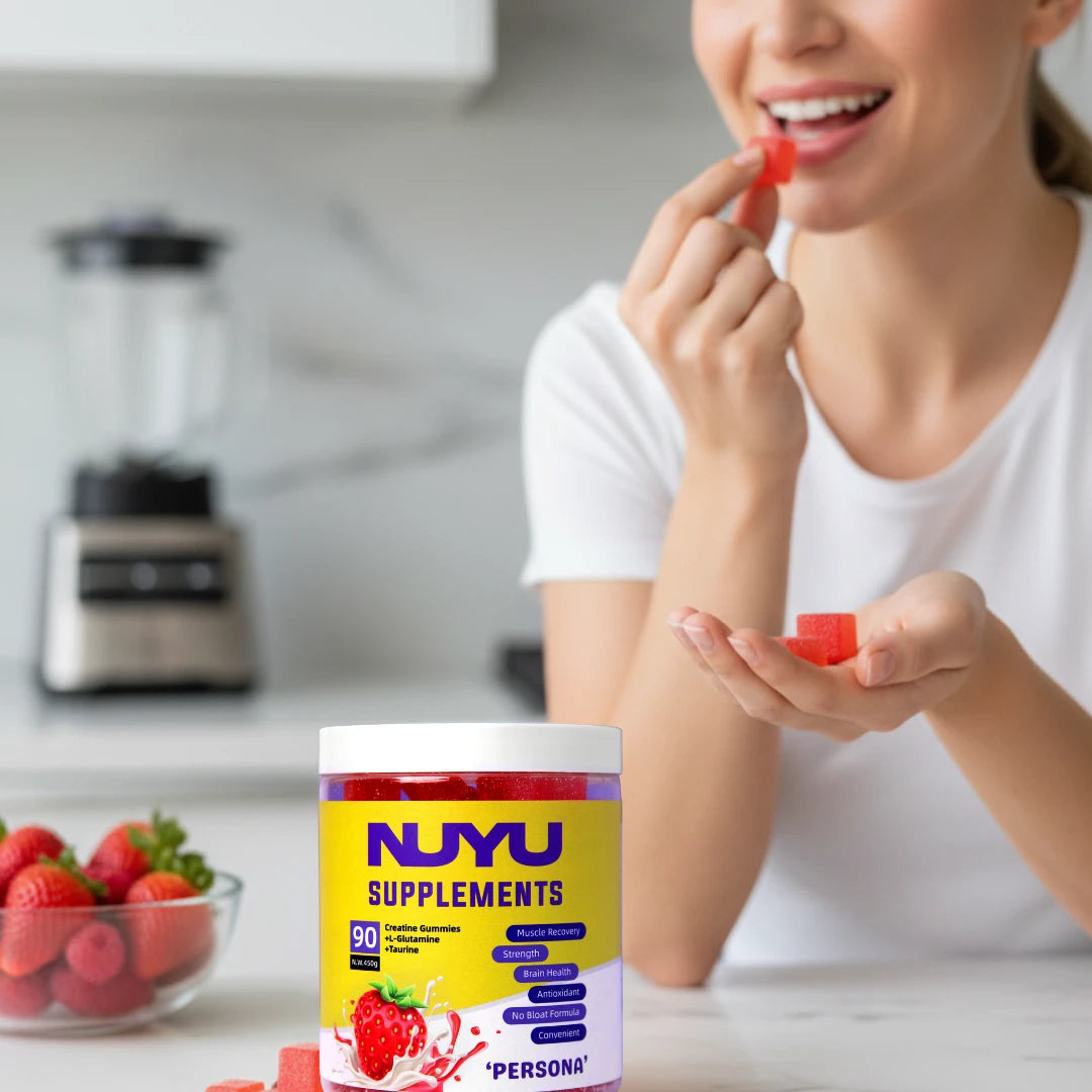Lady eating NUYU Persona 3-in-1 creatine gummy in her kitchen